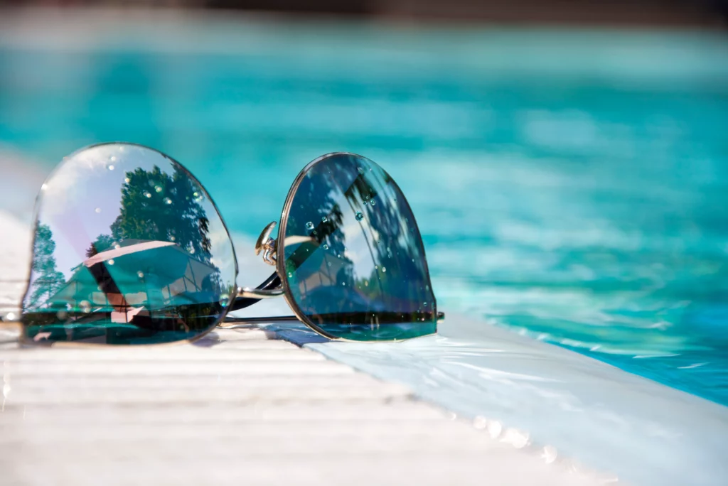 Btl remodels and pools sunglasses near pools edge.